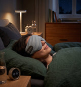 Dreamlight 4S sleep mask worn while sleeping in bed at night