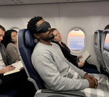 Dreamlight 4S sleep mask worn on a flight for travel